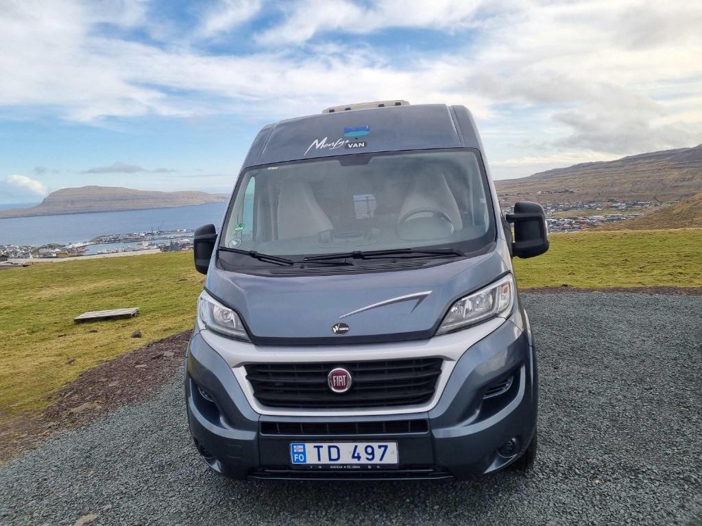 a silver van parked on the side of a road at Adventure Campervan to Explore the Faroes in Hoyvík