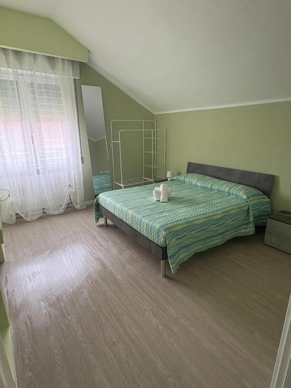 a bedroom with a bed and a window at La Concordia Serravalle Outlet in Serravalle Scrivia