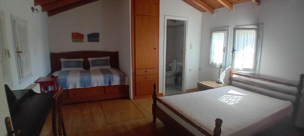 a bedroom with a bed and a dresser in it at Mesakti in Armenistis