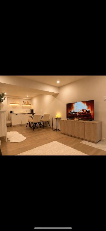 a living room with a large tv on the wall at Modern private apartment - Warm atmosphere in Repentigny