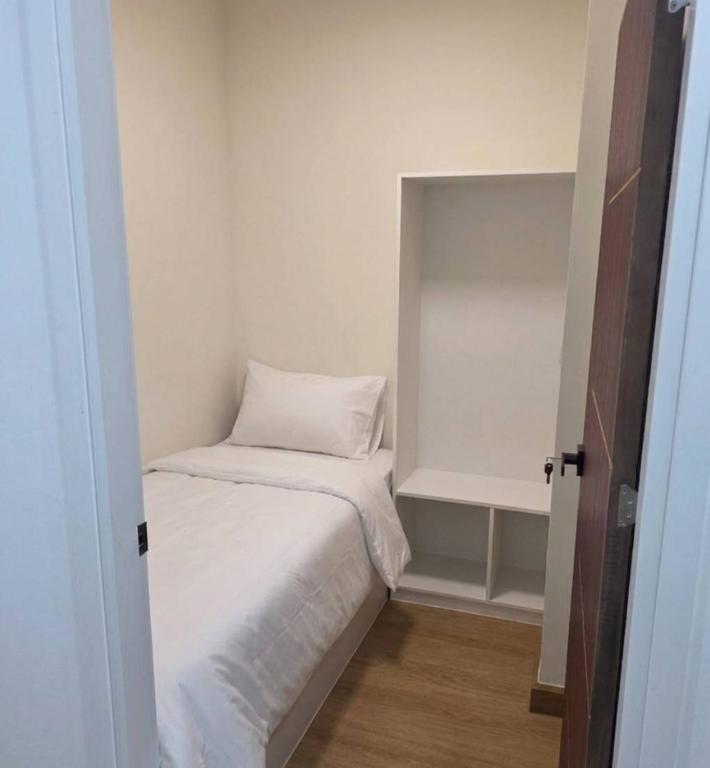 a small room with a bed with a pillow on it at Hotel Backpack BTS ปุณณวิถี in Bangkok