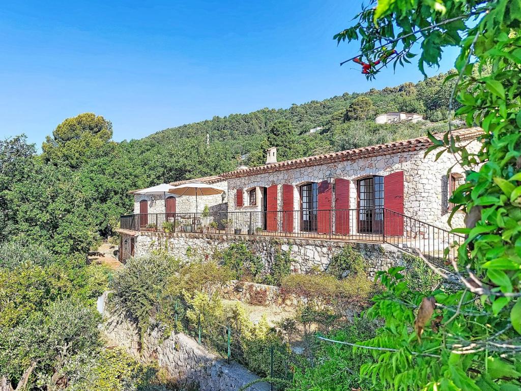 a stone house on a hill with a mountain at Villa Balcon d'Azur by Interhome in Spéracèdes