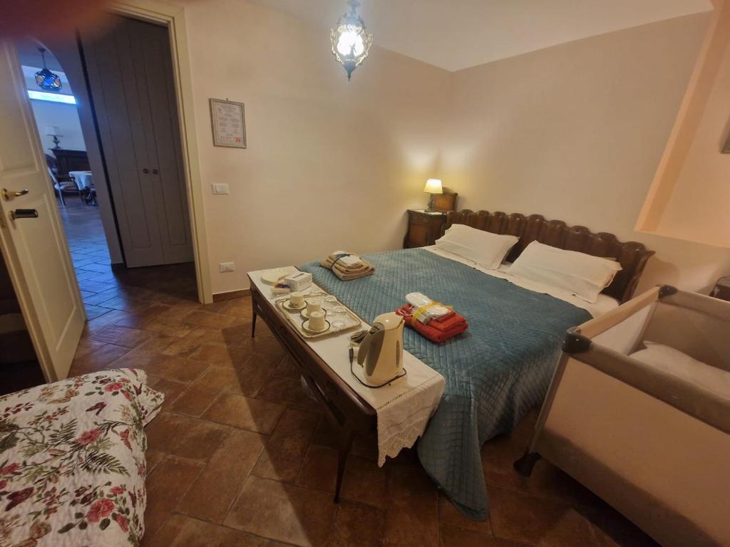 a bedroom with a bed with a table and a couch at Linda's Retreat B&B in Fiano Romano
