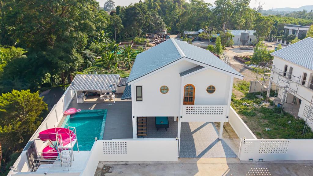 an aerial view of a white house with a swimming pool at Amornrut Hill 03 in Ban Tao Than