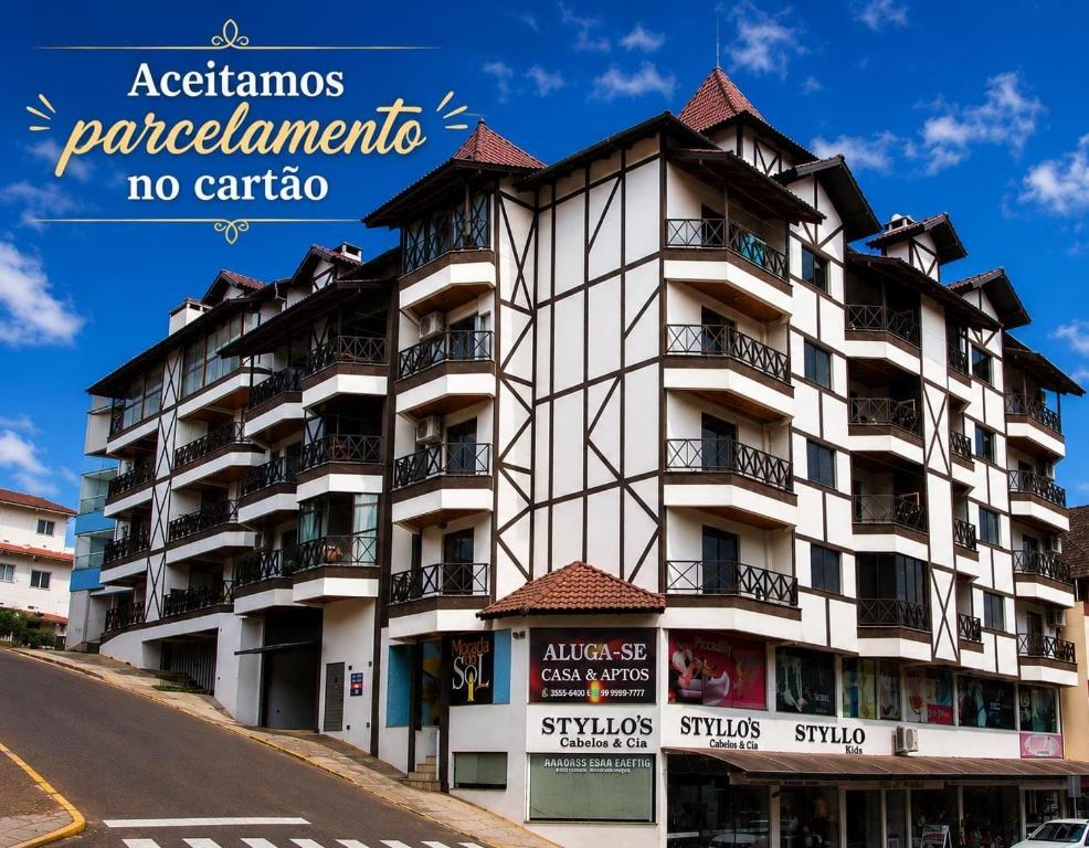 a tall white building on the side of a street at Studio na Morada do Sol in Piratuba