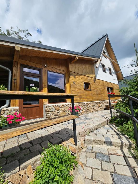a wooden house with a bench in front of it at JIROTOVY BOUDY II in Telnice