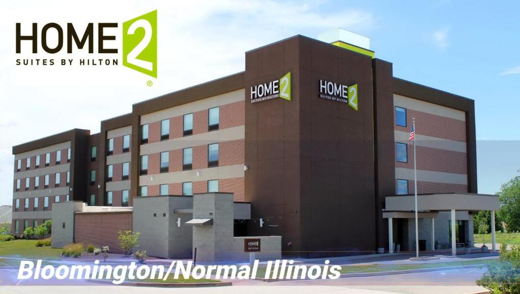 a rendering of a building with the words home blomidon normal mills at Home2 Suites By Hilton Bloomington Normal in Normal