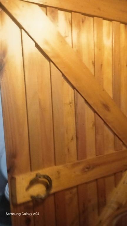 a close up of a wooden wall with a door at La Agraria in Junín