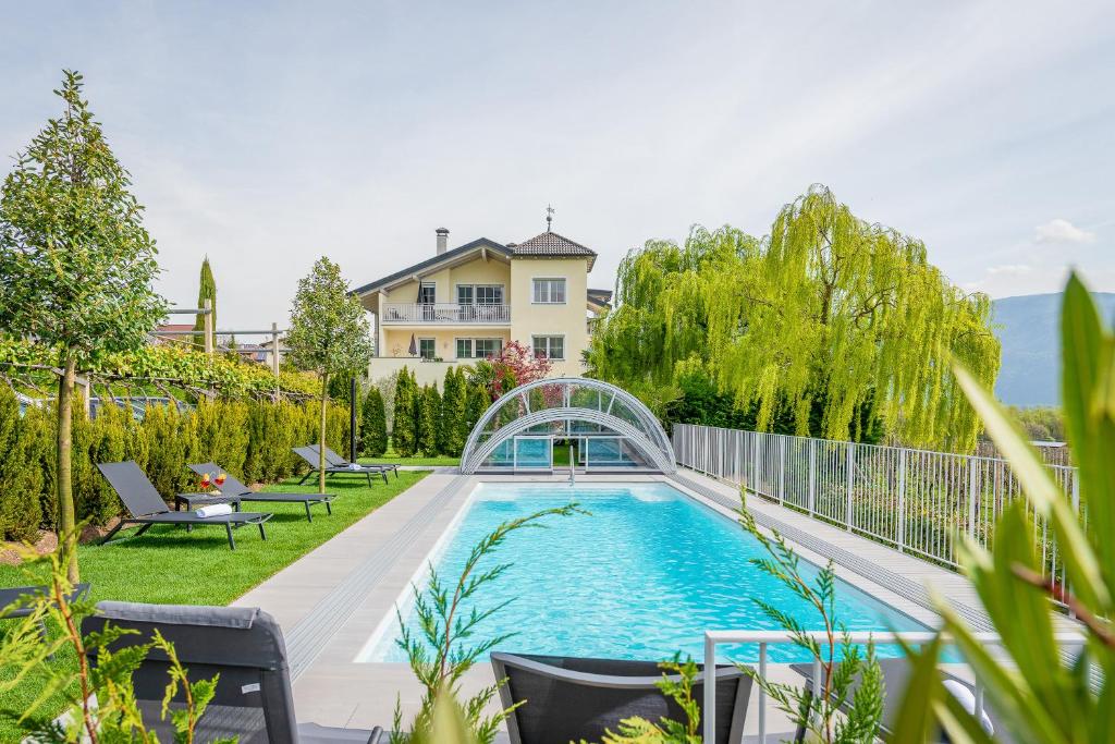 a swimming pool in the backyard of a house at Quellenhof in Termeno