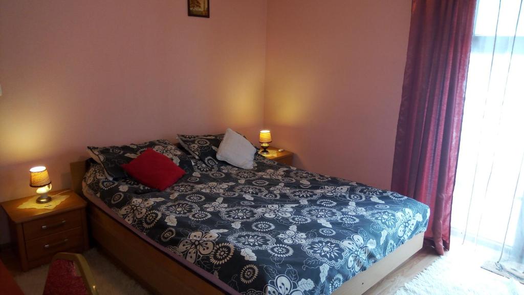 a bedroom with a blue and white bed with two lamps at Agroturystyka w Dolinie Narwi in Łomża