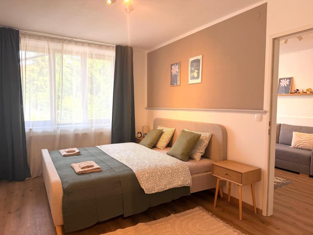 a bedroom with a bed and a window at Apartments Chloe - Top 1 in Hollabrunn