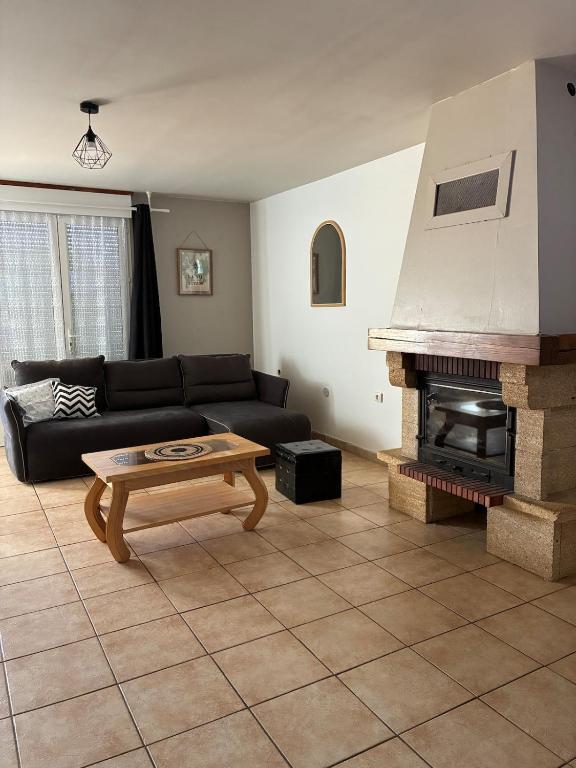 a living room with a couch and a fireplace at maison bozouls in Bozouls