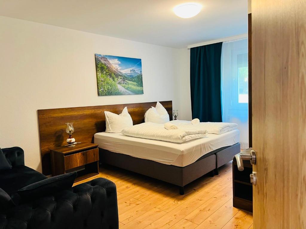 a bedroom with a bed and a couch at Haus Wandertal in Zella-Mehlis