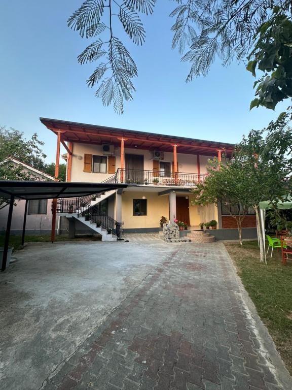 a building with a porch and stairs in front of it at Suc Valley in Klos