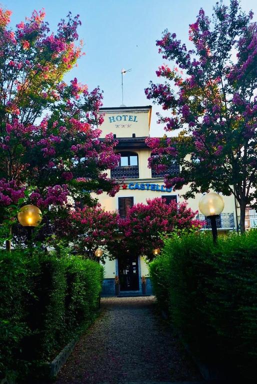 a hotel with flowering trees in front of a building at Hotel Castello in Turin