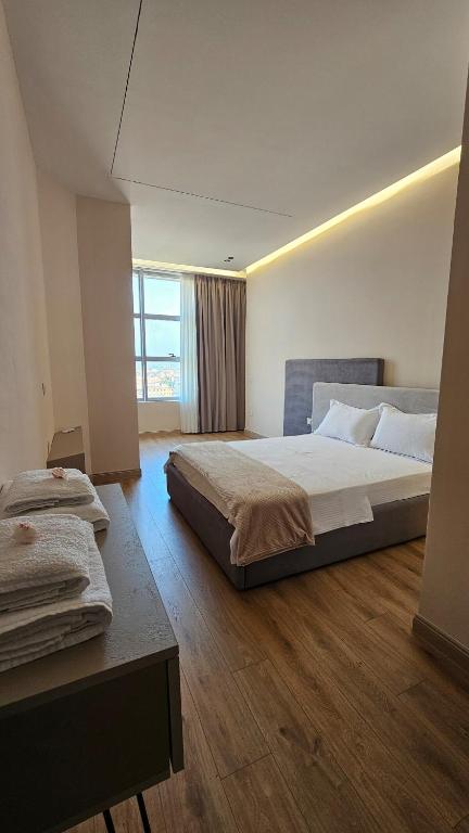 a hotel room with two beds and a window at The Center 104 in Polisi i Vogël