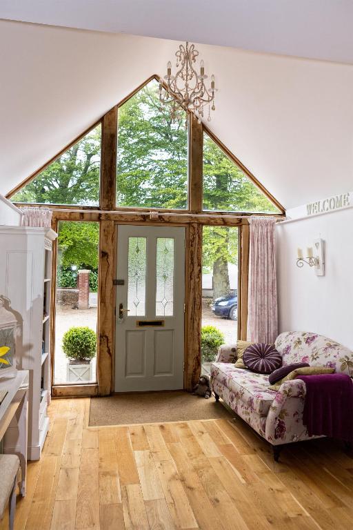 a room with a large glass door with a bed in it at Fring House Bed and Breakfast in Seaton