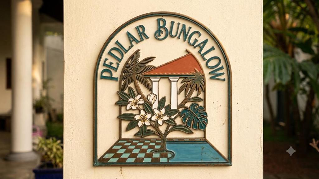 a sign for a hotel with a sign for a building at Pedlar Bungalow in Talpe
