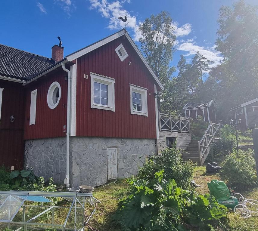 a red house with a stone at The Red Mini Cottage in Huddinge