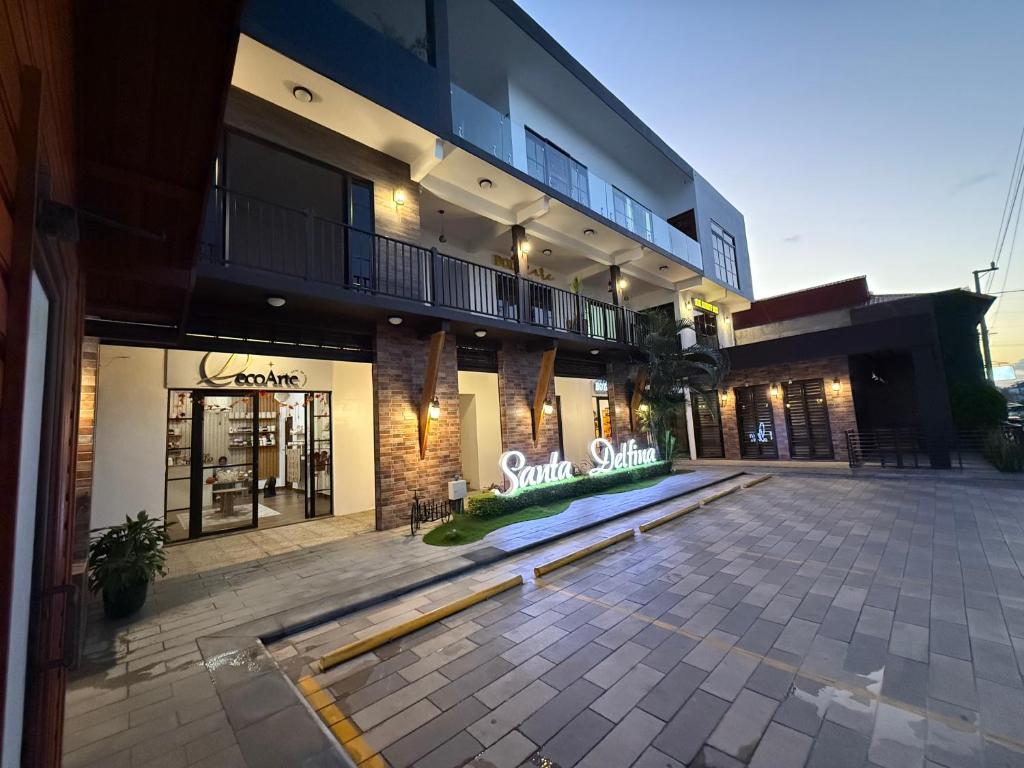 an empty parking lot in front of a building at Santa Delfina Suites in Flores