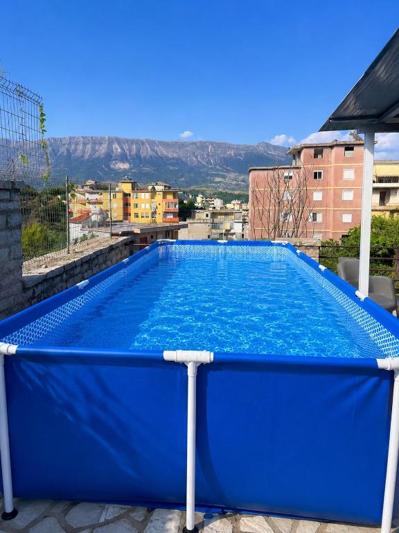 a large blue swimming pool on top of a building at Drasa Harmony Apartment in Gjirokastër