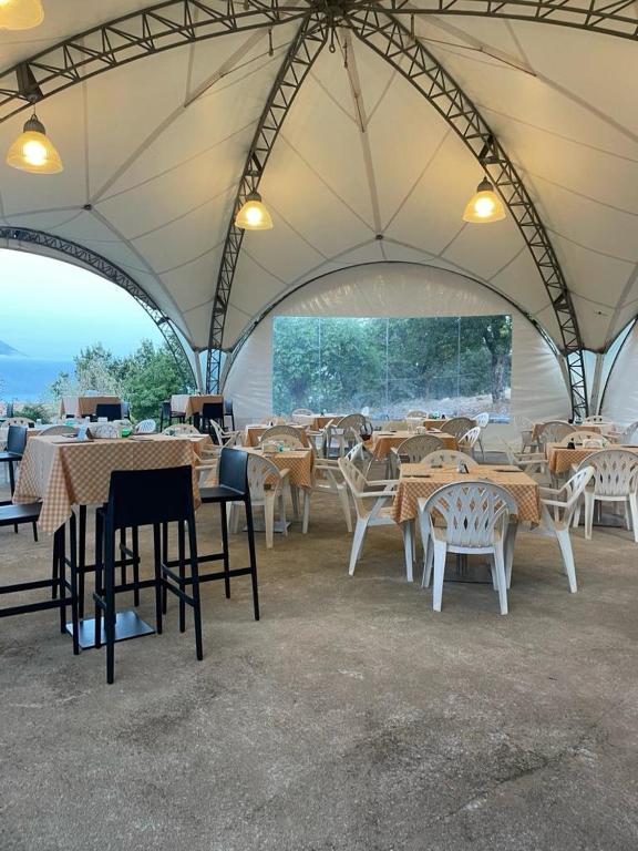 a group of tables and chairs in a tent at Locanda a Bosco in Bosco