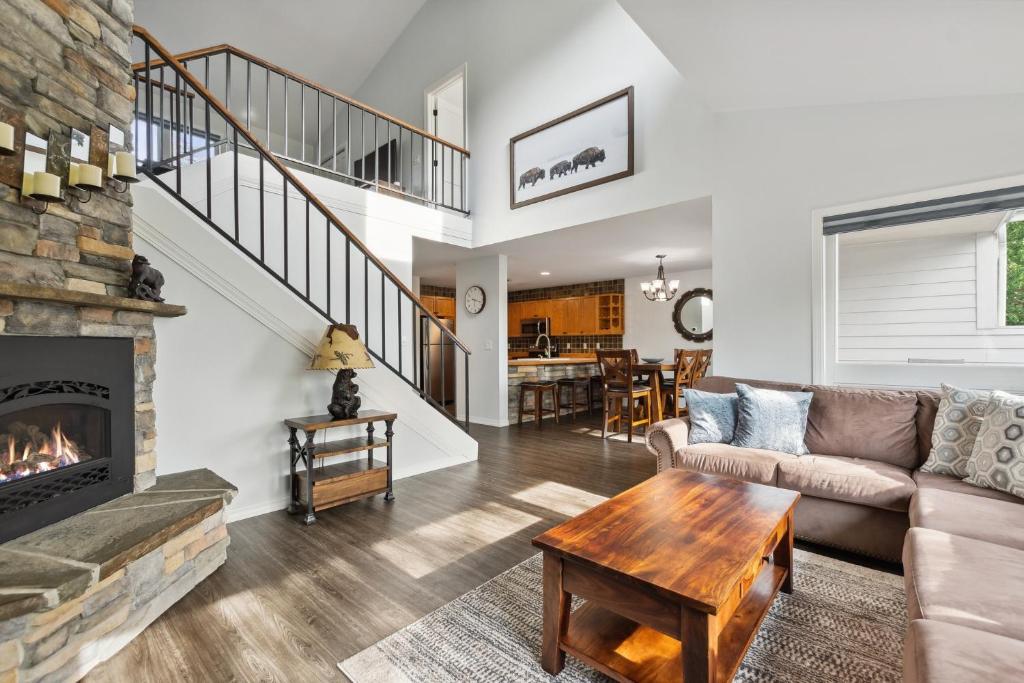 a living room with a couch and a fireplace at Tee Time in Columbia Falls