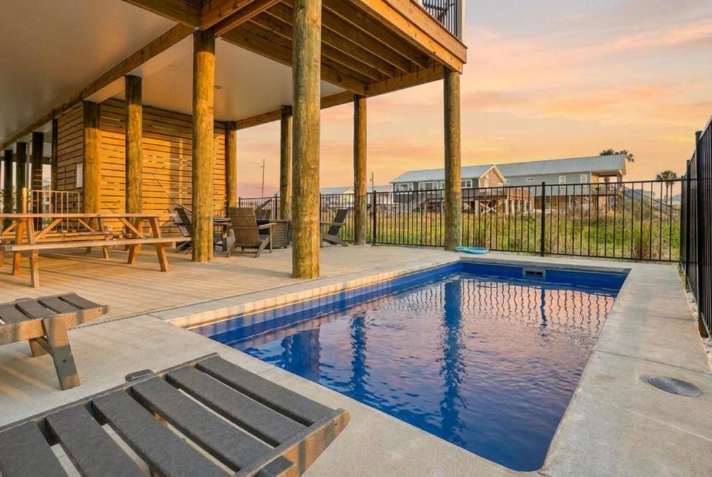 a house with a swimming pool and a deck at Bright Waves Fort Morgan in Gulf Shores
