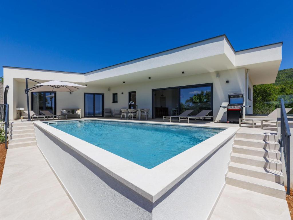 a villa with a swimming pool and a patio at Villa Florinda by Interhome in Raša