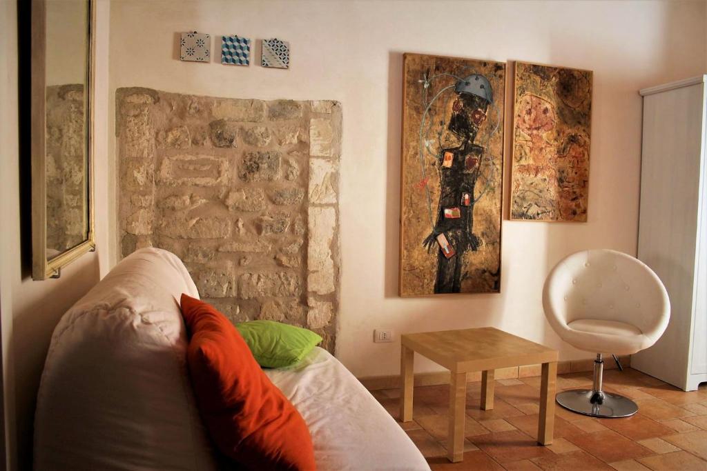 een woonkamer met een bank en een tafel bij Casa vacanze Fuori Tema in Ragusa