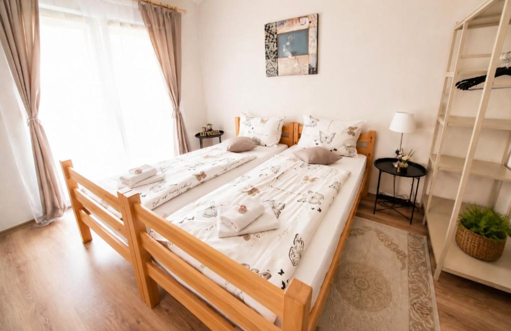 a bedroom with a large bed with white sheets at MB Deluxe Apartment in Visoko
