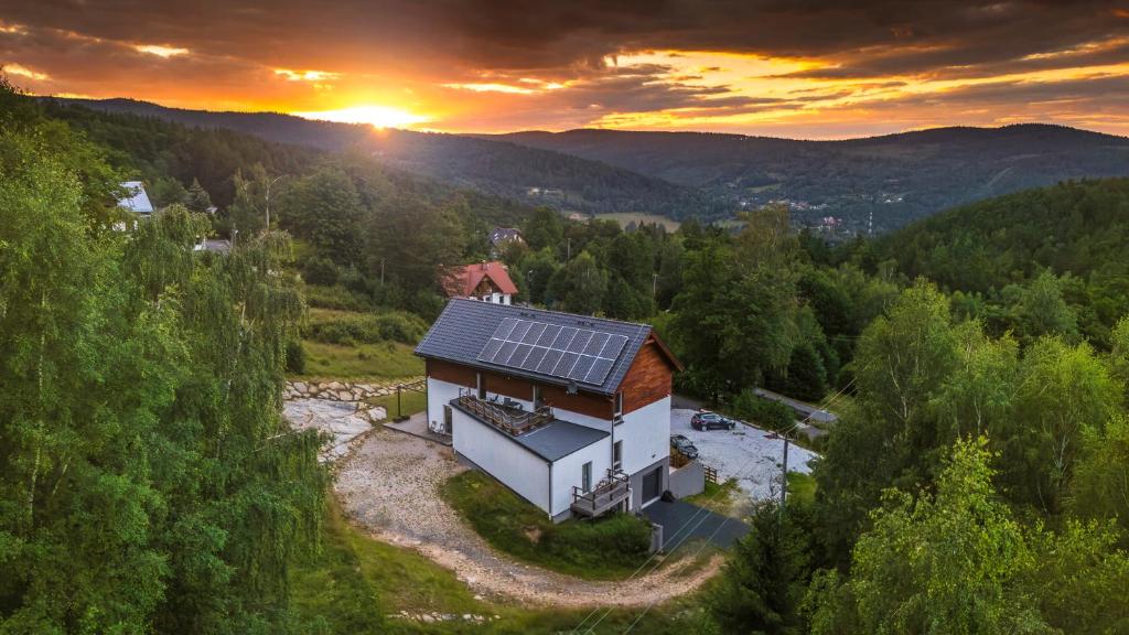 an aerial view of a house with a solar roof at MONTEZERA Butikowe Ekspedycje Sauna i Widok in Piechowice