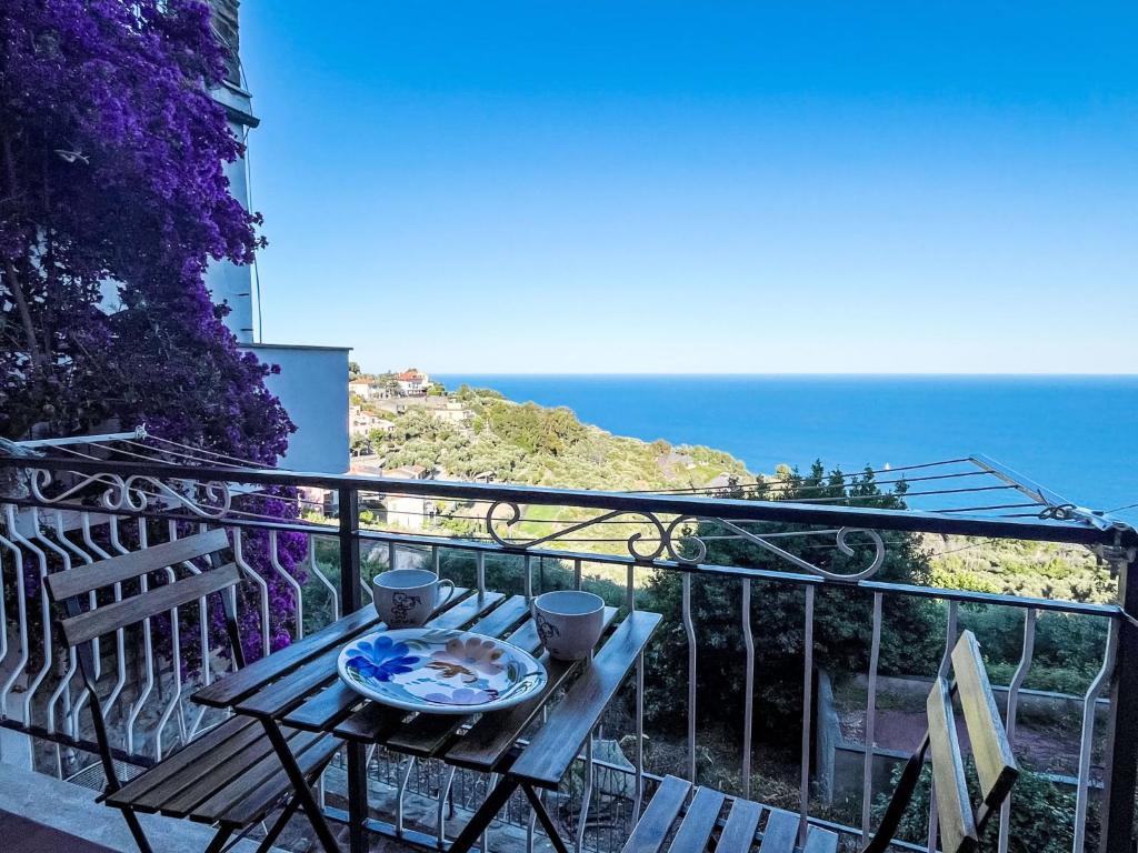 a table on a balcony with a view of the ocean at Apartment Risorgimento Apartment by Interhome in Cipressa