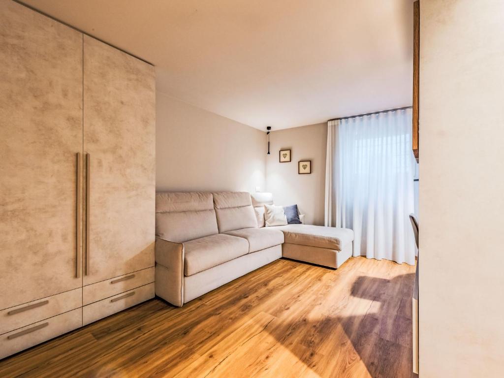 a living room with a couch and a window at Apartment La Spada by Interhome in Ossana