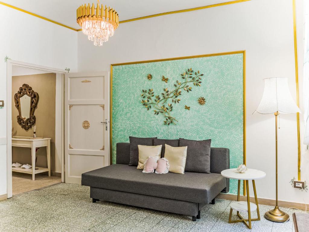 a living room with a couch and a painting on the wall at Apartment Nido nel centro by Interhome in Camaiore