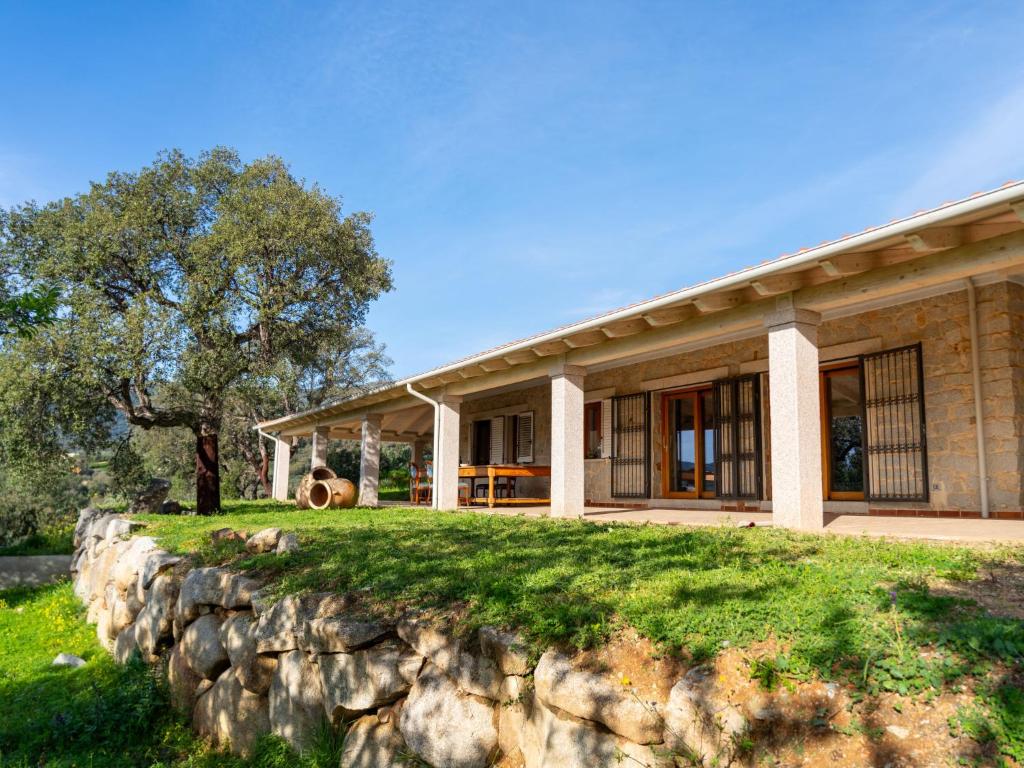 a stone wall in front of a house at Villa S'Olioni by Interhome in Loceri