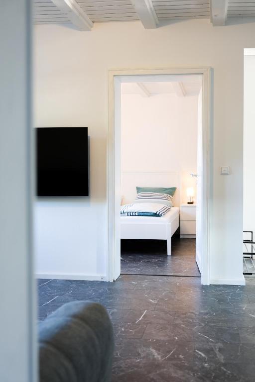 a bedroom with a bed and a tv in a room at Fewo zum Ritzli in Ettenheim