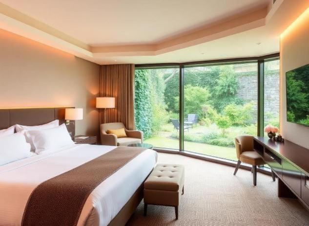 a hotel room with a bed and a large window at Hotel Sedrim in Imperatriz