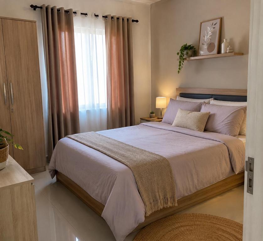 a bedroom with a large bed and a window at Darson Bahau Villa 3 in Kuala Pilah