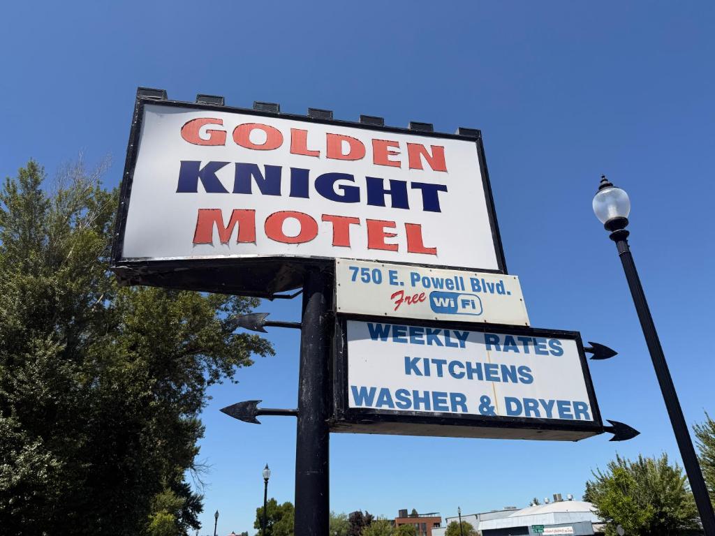 a sign for a golden knight motel on a street at Golden Knight Motel in Gresham