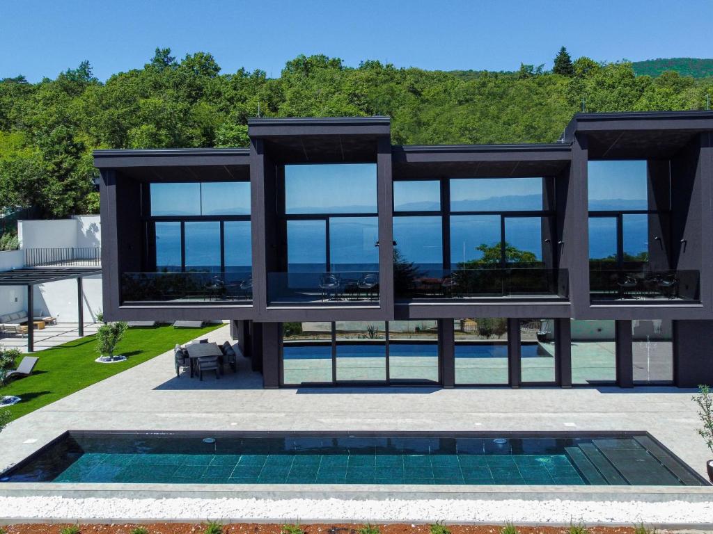 an image of a house with a swimming pool at Villa Black Imperium by Interhome in Mošćenička Draga