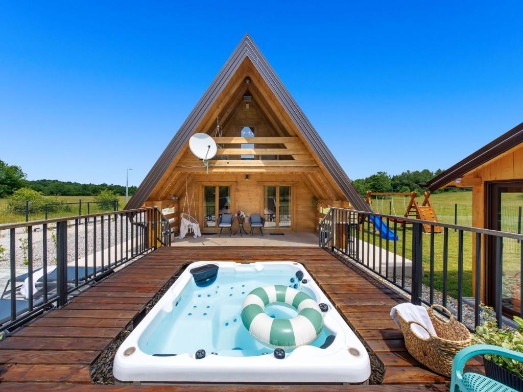 a house with a hot tub on a deck at Chalet Ivica by Interhome in Sveti Rok