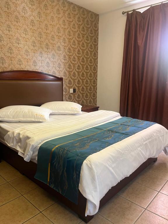 a bedroom with a large bed with at HH Inn in Lagos