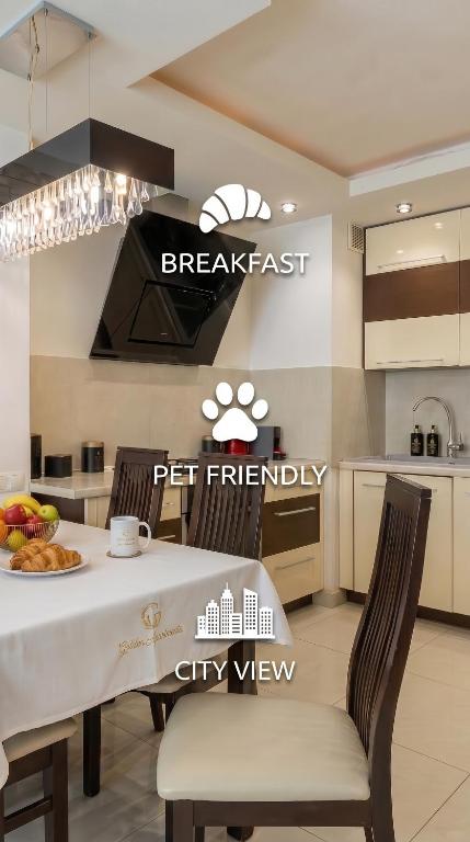a kitchen with a white table and chairs and a kitchen with apertureperture at Urban Chic - One Bedroom Apartment -Luxury Warsaw Stays - Grzybowska 5 in Warsaw