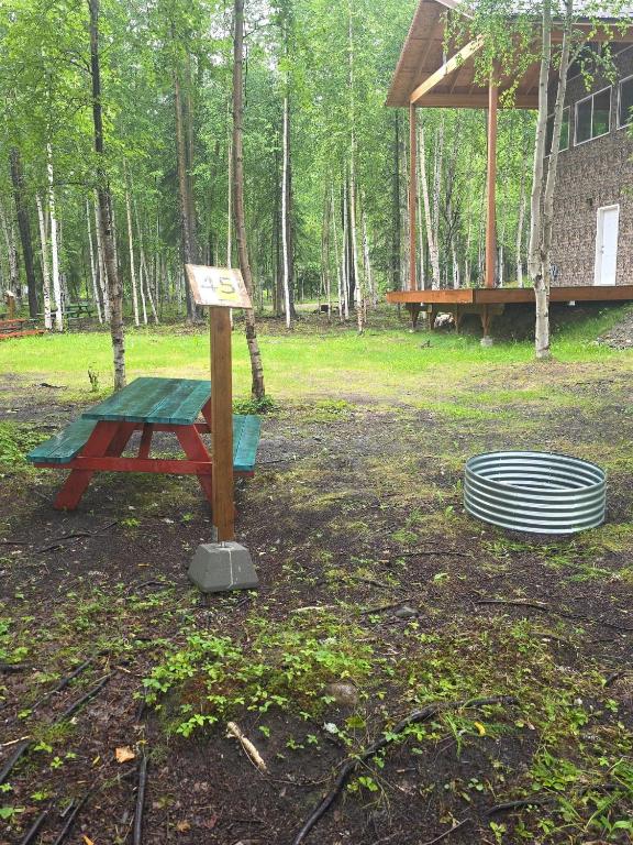 a picnic table and stack of plates in a park at Houston Grass Station Campsite #45 in Wasilla