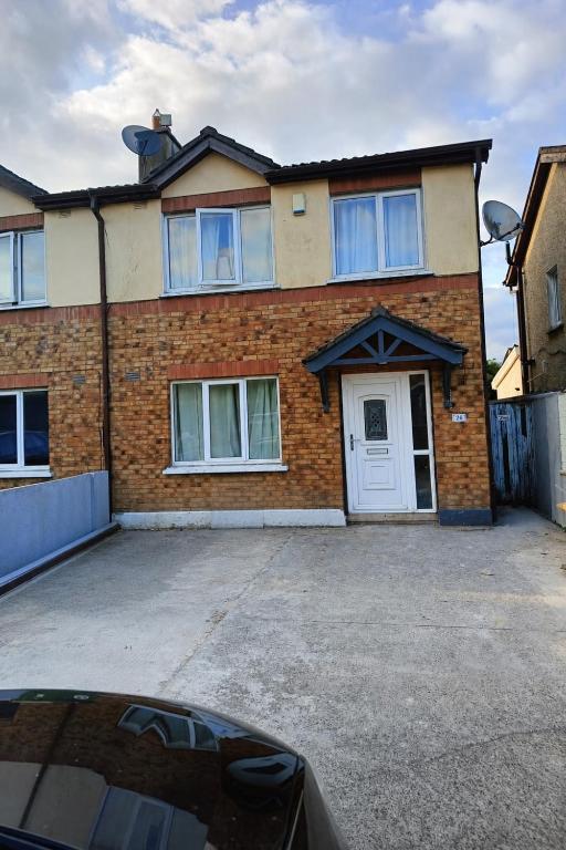 a large brick house with a white door at Dublin Cosy Home in Dublin