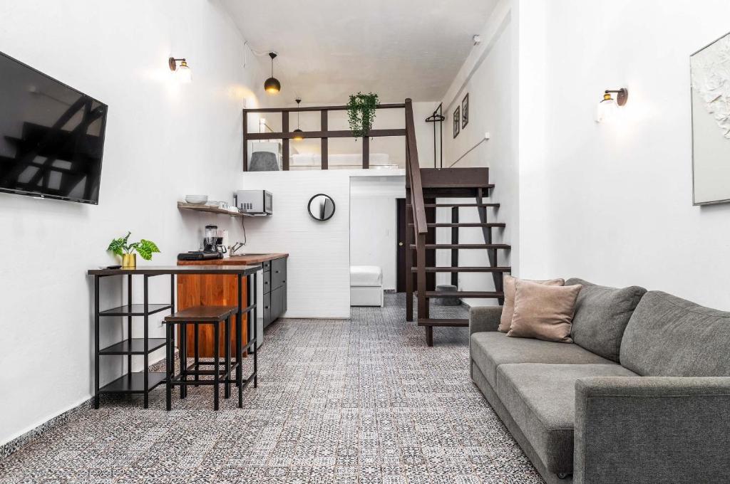 a living room with a couch and a table at Elokut in San Juan