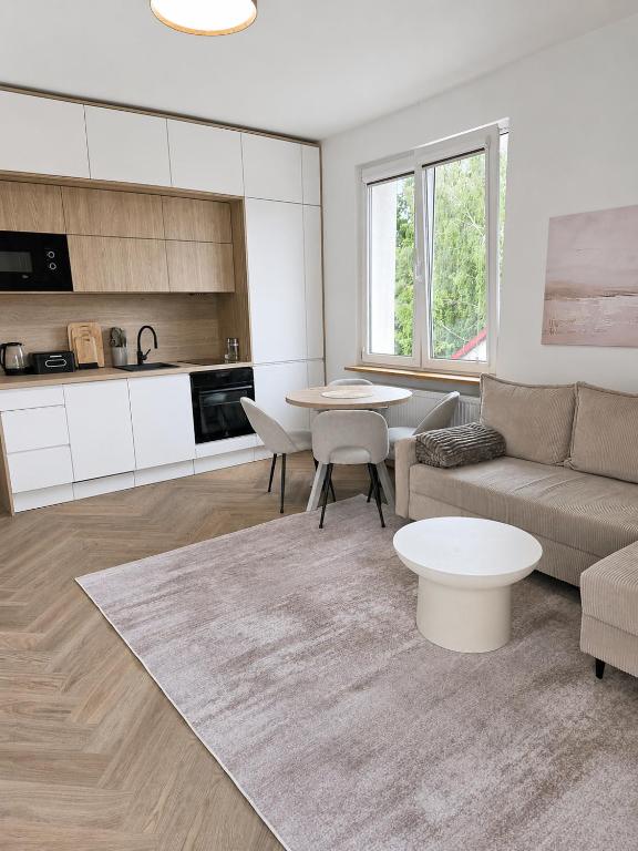 a living room with a couch and a table at Apartament Premium Orzysz in Orzysz