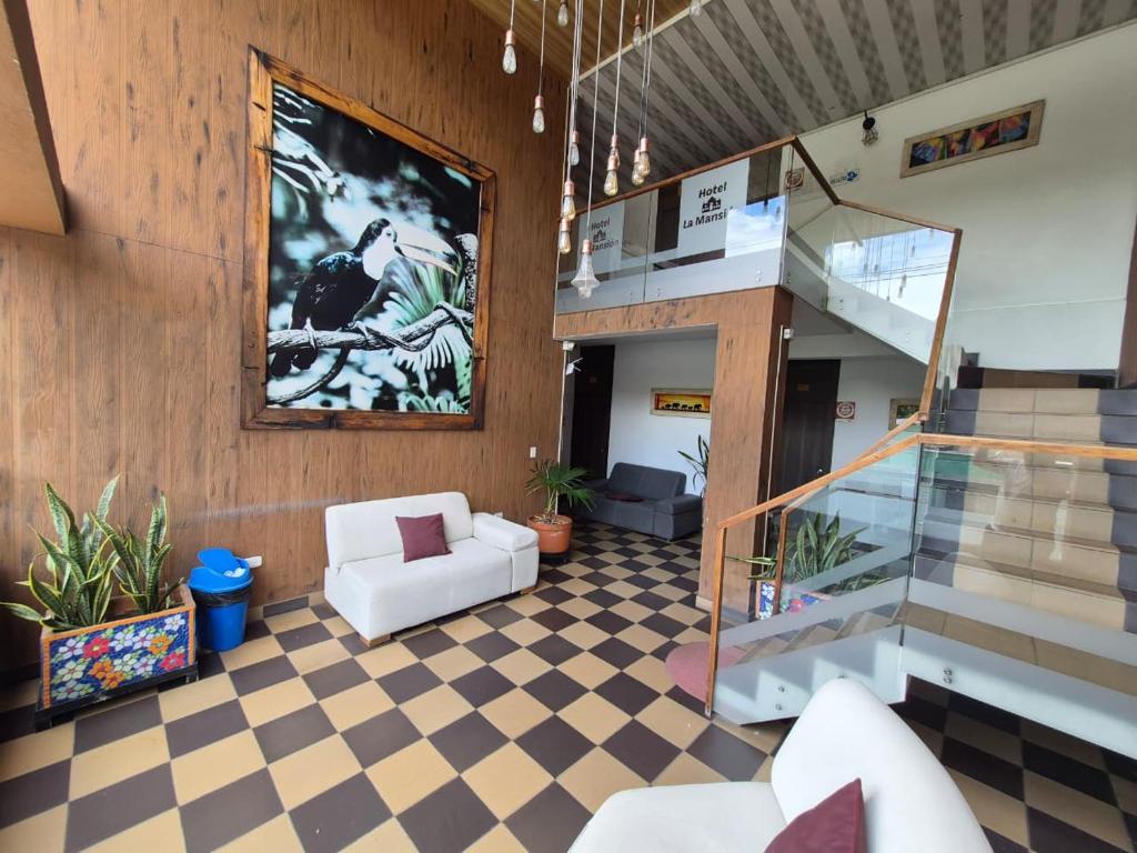 a lobby with a staircase and a living room at Hotel La Mansión in La Pintada