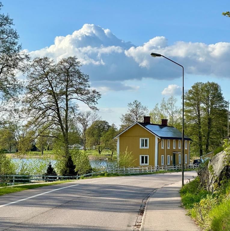 a house on the side of a road with a street light at Villa Gurevitch - 4 lägenheter med sängplats för två i varje lägenhet in Urshult
